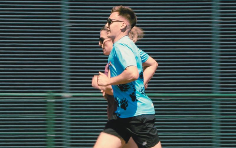 Runner checking heart rate on watch to ensure they are in Zone 2 on an easy run