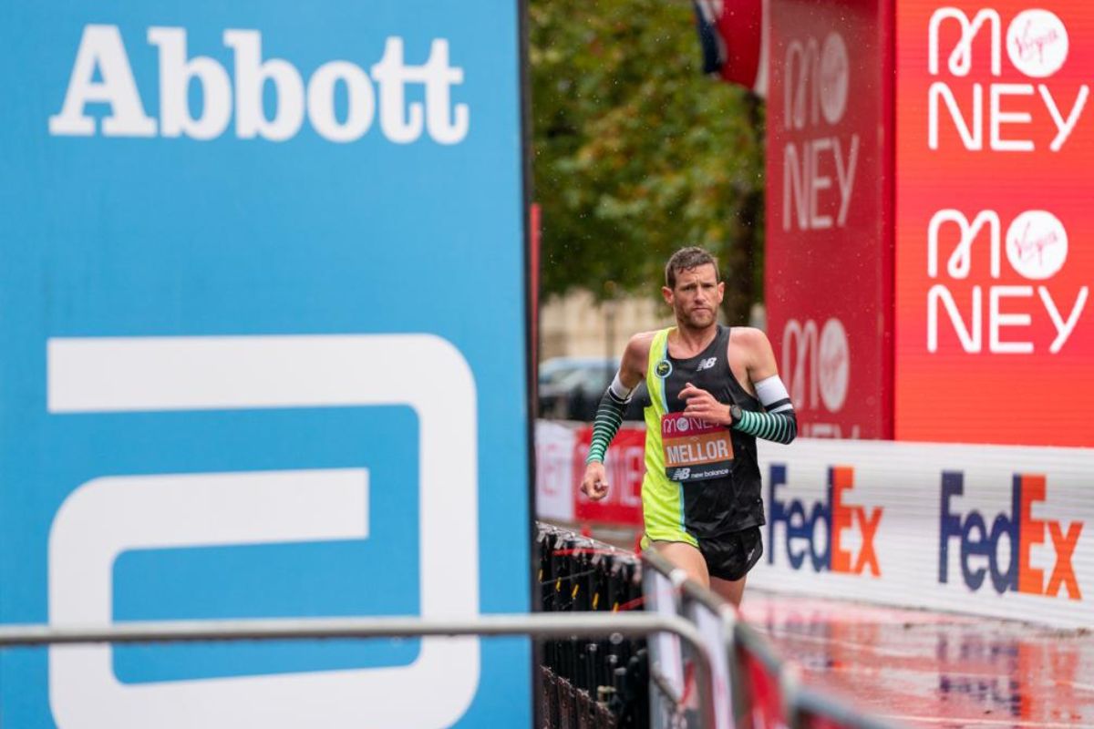 Runner drinking from a cup at a marathon water station