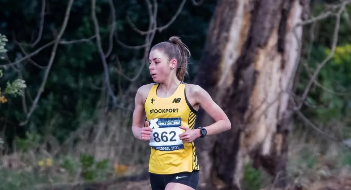 Manchester runner competing in a cross country race, coached by JM Coaching